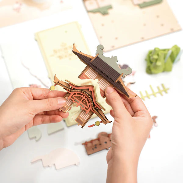 DIY bookshelf insert featuring peaceful village scene