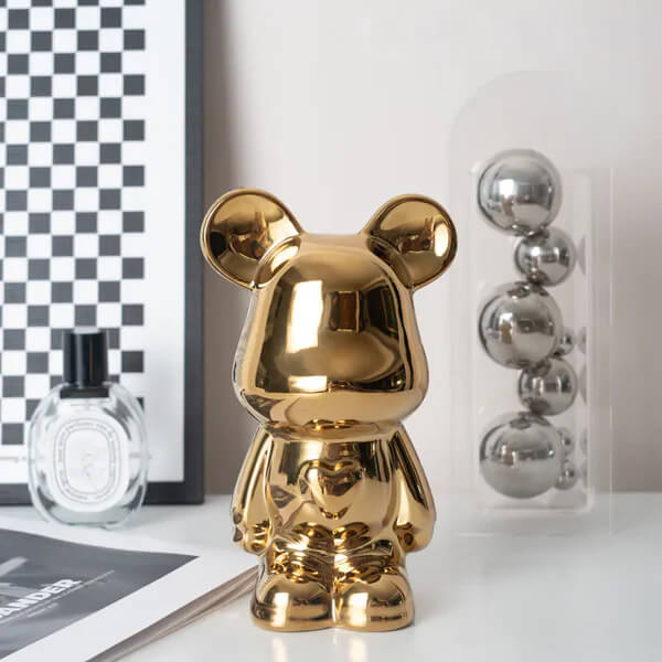 Gold ceramic bear coin bank displayed on a shelf