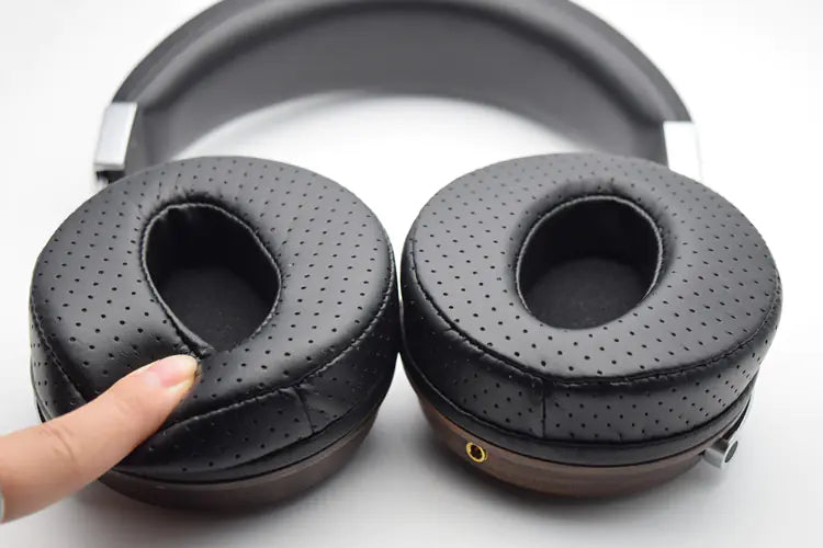 Black perforated memory foam ear pads on over-ear headphones