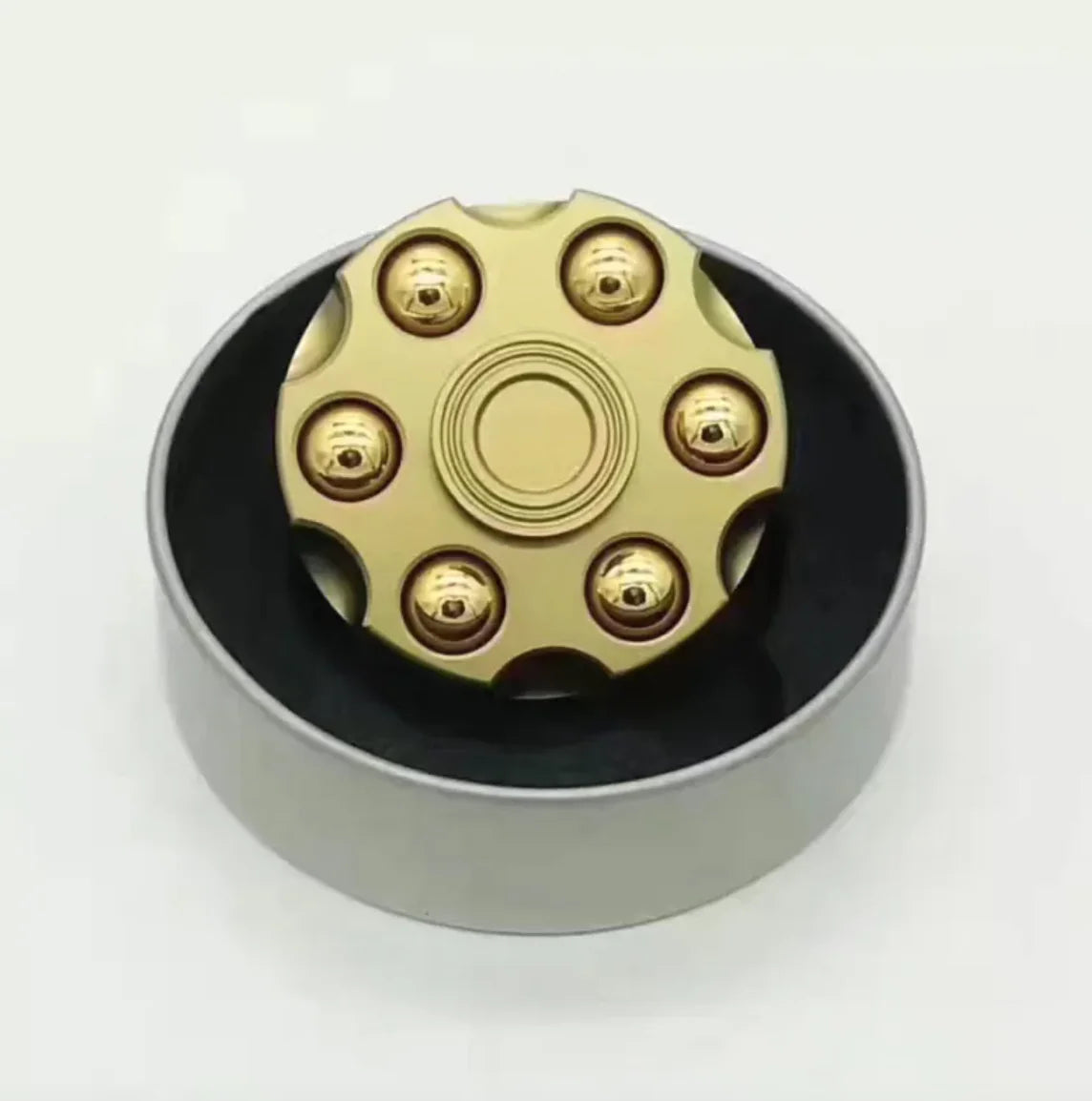 Novelty brass spinner toy shaped like a mini revolver