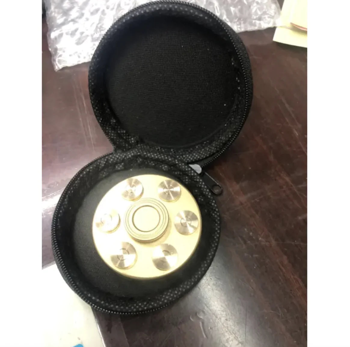 Revolver-style spinner with detachable bullets for interactive play