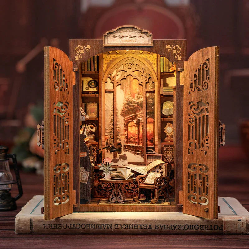 Wooden bookstore book nook kit glowing on a bookshelf