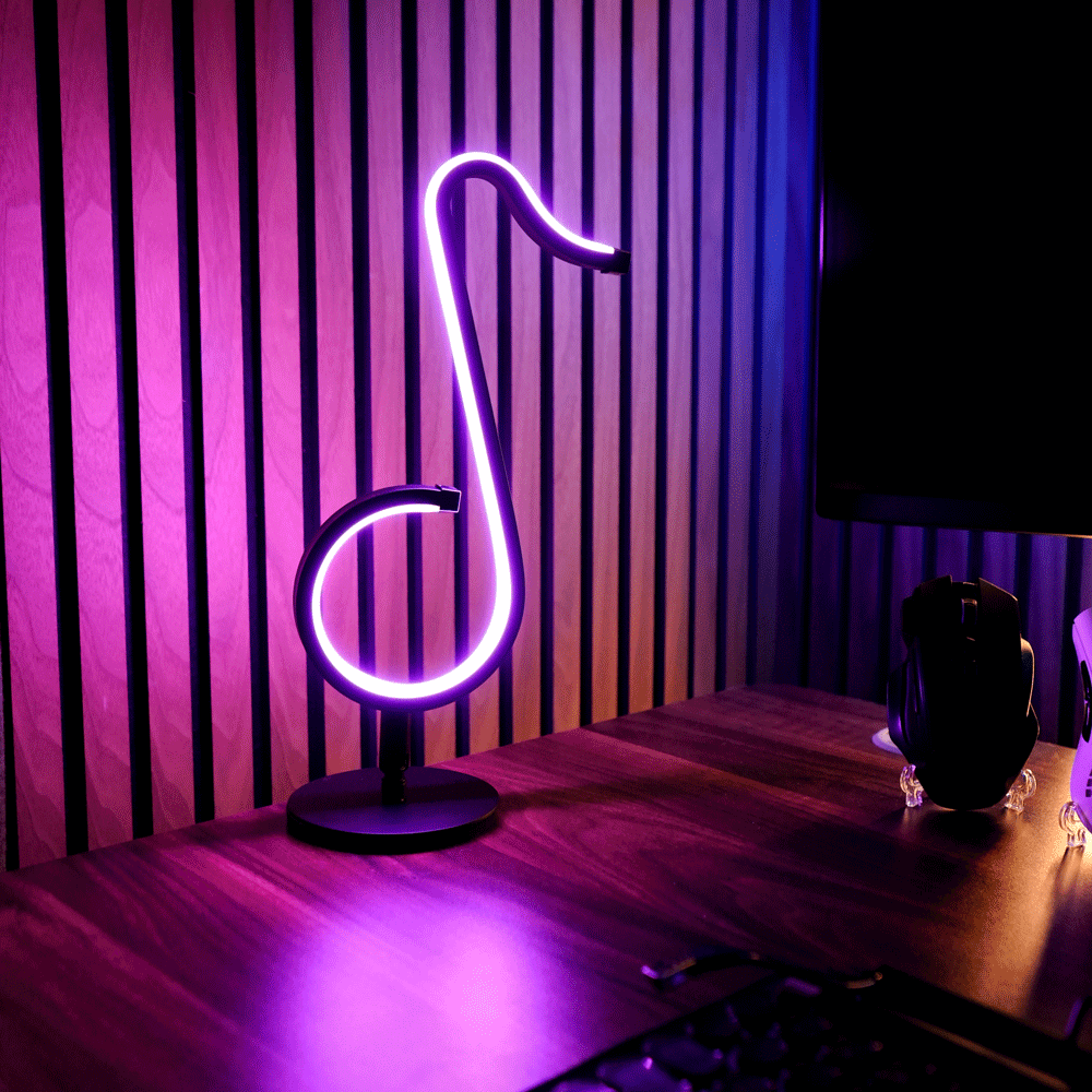 Neon light shaped like a music note on a desk with striped purple wall in the background