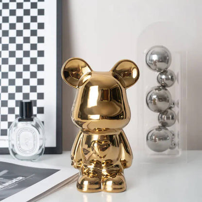 Gold ceramic bear coin bank displayed on a shelf