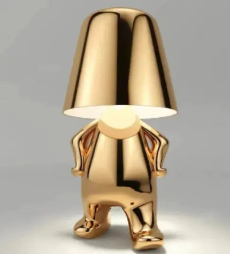 Gold thinker desk lamp standing with hands on hips and minimalist design