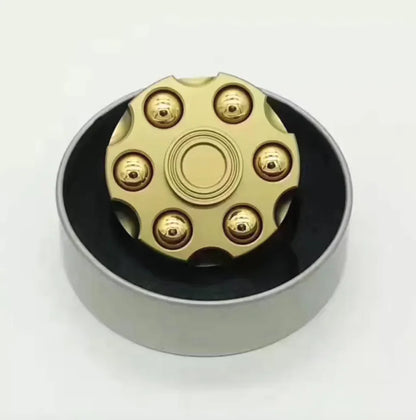 Novelty brass spinner toy shaped like a mini revolver
