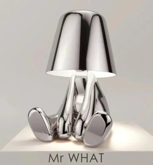 Silver thinker lamp sitting sideways in relaxed pose